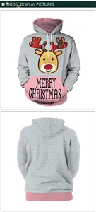 Detail view of grey Christmas hoodie with reindeer print and pink patchwork accents