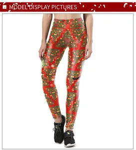Detail showing high-waisted red leggings with festive green and gold Christmas tree prints