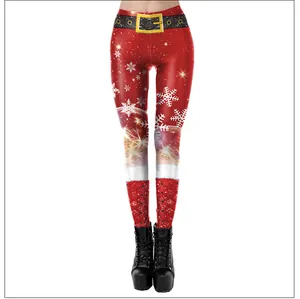 Detailed view of red Christmas leggings featuring snowflake prints and faux gold belt buckle