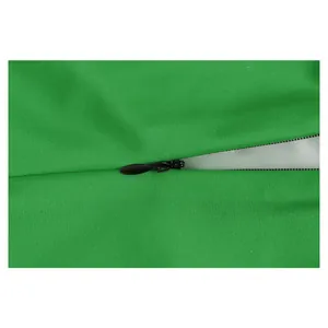 Close-up of green fabric with high-quality black invisible zipper on performance costume