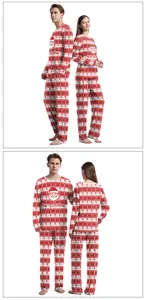 Detail of Christmas couple pajamas featuring red Santa motifs and Merry Christmas text