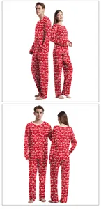 Close-up of red Christmas pajamas featuring white HO HO HO lettering and snowflakes