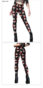 Detail view of high-waisted Christmas leggings with black cat and snowflake digital print