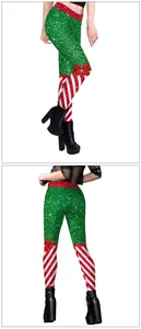 Detailed view of festive Christmas leggings with green glitter and red bow prints