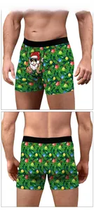 Front and back view of men's Christmas boxer shorts with pine and ornament patterns