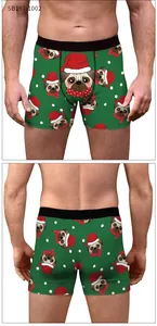 Detail of Christmas pug print on men's green boxer briefs with black elastic waistband