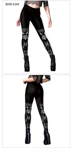 Detail view of dark gothic leggings showing cat print and crescent moon patterns on knees