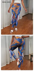 Detail of mermaid leggings showing side fin decorations and vibrant scale printing