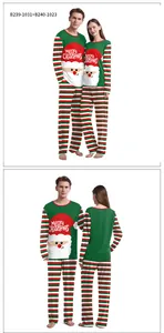 Detail of Christmas couple pajamas featuring Santa Claus print and festive striped pants