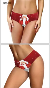 Detailed view of red Christmas panties with cartoon Santa Claus and snowflake prints