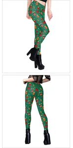 Close-up of Christmas leggings with festive bells, bows and gift patterns for women