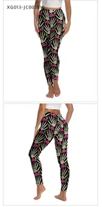 Detail of high-waisted Halloween leggings with skull bones and pink floral pattern
