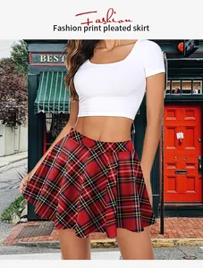 Detail of red plaid pleated skirt in Scottish tartan print on model in street setting