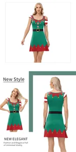 Detail of Christmas elf dress featuring red scalloped edges and gold bells on green fabric