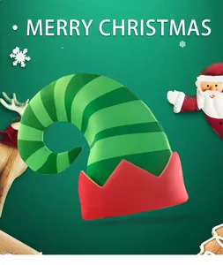 Detailed view of striped green Christmas elf hat with red sawtooth trim on festive backdrop