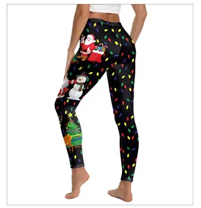 Detail view of high waist Christmas leggings with festive santa and reindeer digital prints