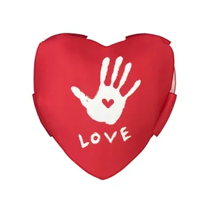 Red heart-shaped sponge pillow with handprint and LOVE print for Valentine couples