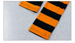 Detail of double-needle stitching on orange and black striped Halloween leggings cuff