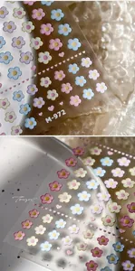 Macro detail of 3D embossed floral nail stickers in pastel colors for DIY manicure