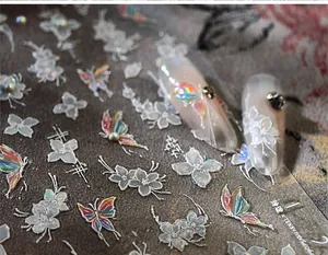 Macro detail of TL-352 nail stickers with 3D aurora butterflies and white floral patterns