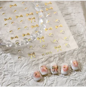 Detailed 3D gold embossed nail stickers with bow knots and strawberry motifs M-998