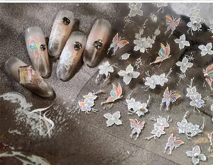 Detail view of aurora butterfly flower nail stickers with 3D pearl and metallic accents