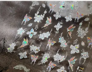 Detailed close-up of 3D holographic butterfly and floral nail art stickers with aurora effect