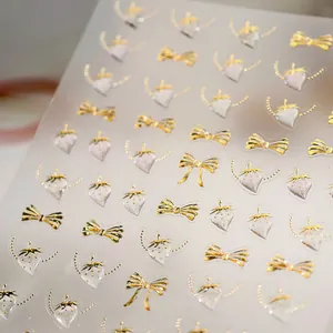 Golden bow and strawberry nail stickers with premium gold foil texture for elegant nail art