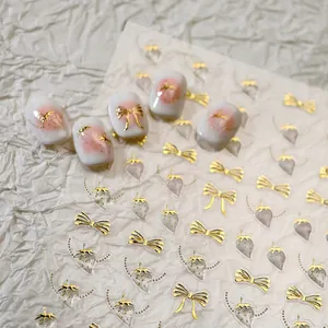 Golden embossed bow and strawberry 3D nail art stickers with elegant matte finish