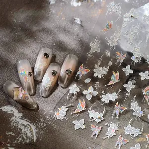 3D embossed nail art stickers featuring white floral patterns and aurora butterflies