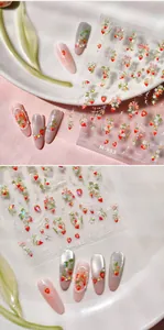 Detail of M-993 strawberry nail stickers applied on various color nail tips