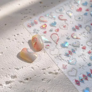 Macro detail of laser holographic heart and ribbon bow 3D embossed nail art stickers