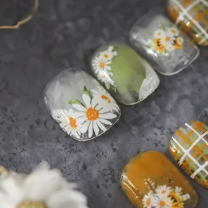 Daisy and orange plaid self-adhesive nail stickers with floral patterns on stone background