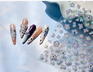 Macro view of 5D embossed floral nail stickers with purple and blue flower designs
