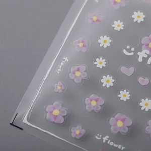 Stereo floral nail stickers with purple flowers and white daisies on a grey background