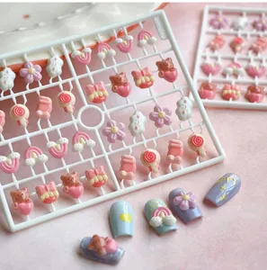 Vue macro détaillée de charmes d'ongles en résine 3D arc-en-ciel et ours sur support