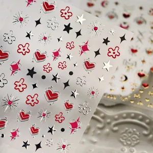 3D metallic nail art stickers featuring red heart and silver star patterns on white ceramic