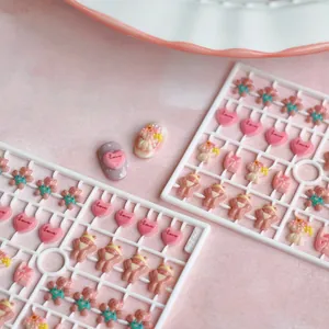 Cute resin nail art set with pink bears and heart charms on a white mold TX050