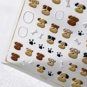 Macro shot of 3D embossed nail stickers featuring cute cartoon dogs and bone patterns