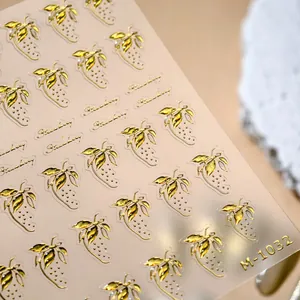Golden embossed strawberry nail stickers with 3D metallic texture and M-1032 branding
