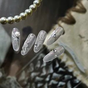 Elegant 3D white butterfly wing press-on nails with pearls on a mirror surface