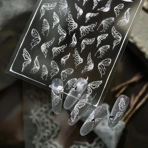 3D white angel wing nail art stickers with embossed texture and butterfly design