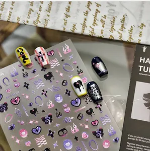 Detail of dark aesthetic nail stickers featuring purple hearts and silver flame designs