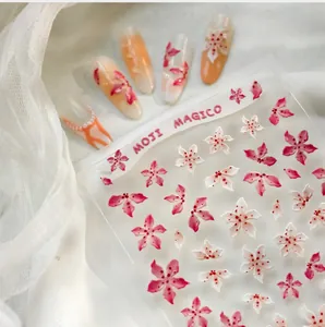 Macro detail of 3D embossed pink and white flower nail art stickers on a mesh background