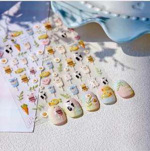 Close-up of cute cartoon embossed nail art stickers with animal and ice cream motifs