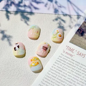 3D embossed press-on nails with cute animal and daisy designs in cream colors