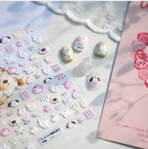 Macro shot of 3D embossed nail stickers featuring cute cartoon dogs and rabbit motifs