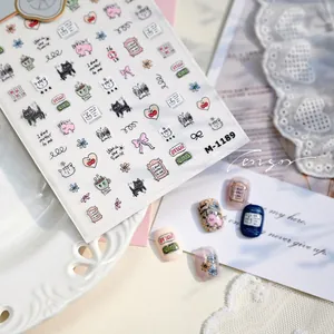 Detailed view of hand-drawn cat and rabbit nail stickers M-1189 applied on nails