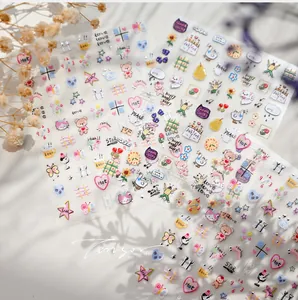 Detail shot of cute panda and cat nail art stickers with rainbow and heart patterns
