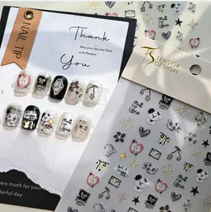 Detail view of 3D embossed nail stickers featuring cute dog, heart and clock patterns